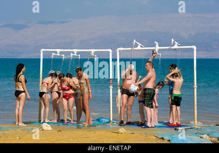 DEAD SEA, ISRAEL - OCT 13, 2014: People are taking a shower after they floated in the water of the dead sea in Israel Stock Photo