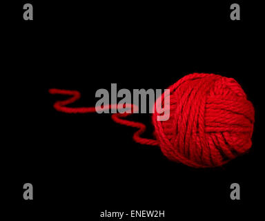 Bright red ball of yarn isolated on black. Stock Photo