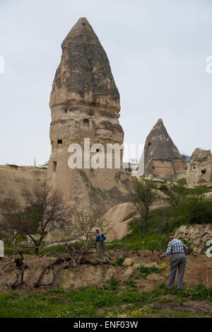 Local man and woman tending their vineyard near Durmus Kadir Church, Karsibucak, Goreme, Cappadocia, Turkey. Stock Photo