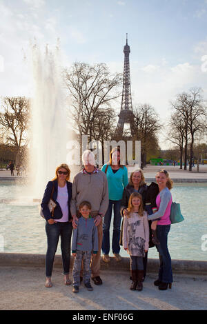 Large family in front of the Eiffel Tower, Paris France