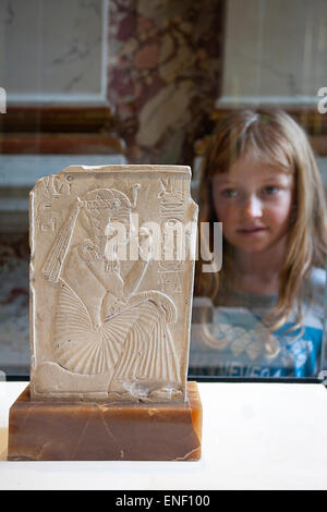 Young girl looking at an Egyptian artifact, Louvre Museum, Paris Stock Photo