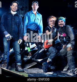 Portrait of a group of people with tools at construction site doing renovations and demolition Stock Photo