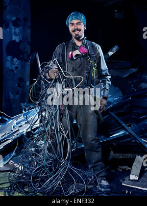 Smiling eletrical contractor at work with a bunch of wires artistic portrait Stock Photo