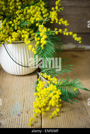 Easter time, yellow mimosa flowers on the old table Stock Photo