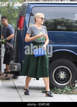 Cougar Town star Busy Philipps out in West Hollywood with family all wearing matching grey t-shirt portraying a flamingo and dog in jewelry t-shirt  Featuring: Busy Philipps Where: Los Angeles, United States When: 30 Oct 2014 Stock Photo