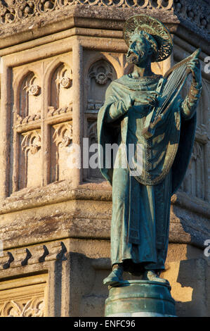 Monuments. A bronze statuette of St Aldhelm, a detail from the ornate Victorian Wingfield Digby Memorial, outside Sherborne Abbey in Dorset, England. Stock Photo