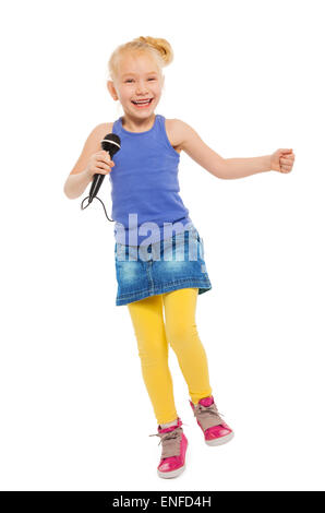 Cute small girl singing in microphone and dancing Stock Photo