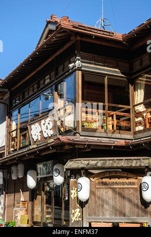 Old wooden Japanese building in traditional style, used as a restaurant. Small town, rural Japan. Stock Photo