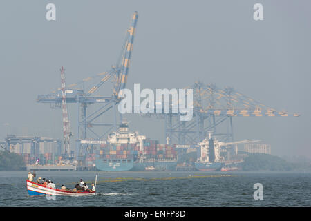 Fishing boat in front of the International Container Transshipment Terminal, ICTT, Vallarpadam Terminal, Kochi, Kerala, India Stock Photo