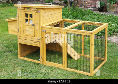 A small home-made wooden hen coop and wire chicken run, portable and suitable for use in a town garden or other urban location (UK) Stock Photo