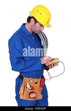 electrician holding a measurement tool Stock Photo