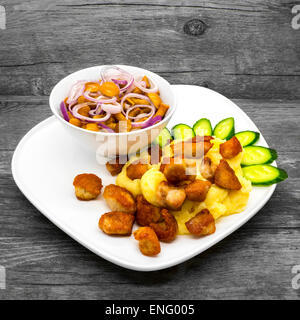 Mashed potatoes with chicken and mushrooms on a wooden background Stock Photo