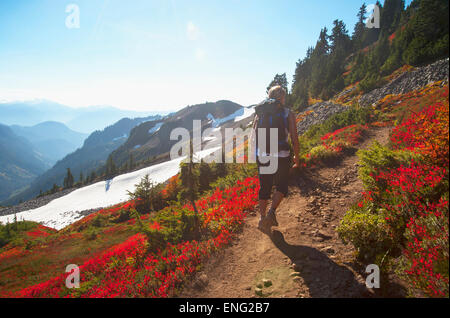 Woman hiking on rocky trail on remote hillside Stock Photo
