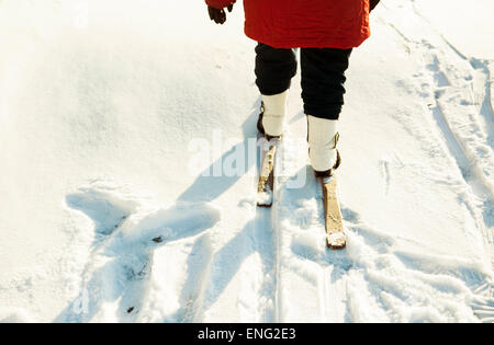 Caucasian woman cross-country skiing in snowy field Stock Photo