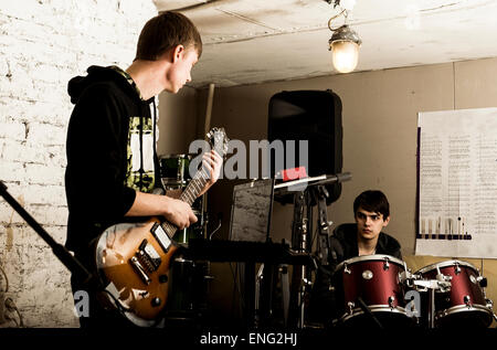 Caucasian musicians playing in rock band Stock Photo
