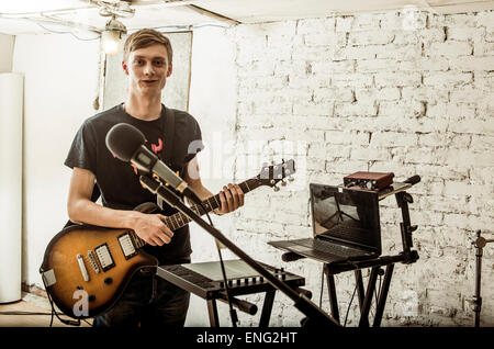 Caucasian man playing electric guitar in rock band Stock Photo