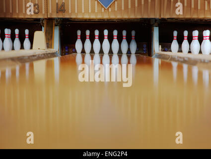 Bowling pins reflecting in bowling alley lane Stock Photo