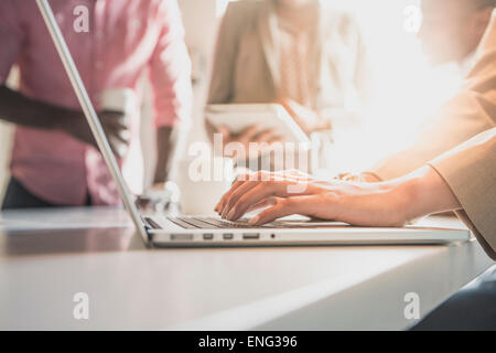 Businesswoman using laptop in office Stock Photo
