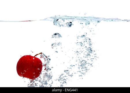Apple falls deeply under water Stock Photo