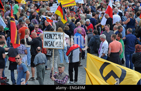 Dresden, Germany. 04th May, 2015. People participate in a rally by anti-Islam movement Pegida (Patriotic Europeans against the Islamization of the West') with Germany flags (L) and flags which were proposed by German resistance fighter Josef Wirmer as a national flag in 1944 (R), in Dresden, Germany, 04 MAy 2015. The 'Patriotic Europeans against the Islamization of the West' (Pegida) have gathered again for another rally in the Saxon capital. Photo: MATTHIAS HIEKEL/dpa/Alamy Live News Stock Photo