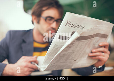 Close up of man reading business section of newspaper Stock Photo