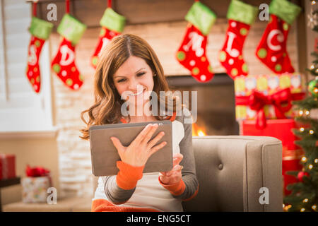Caucasian woman using digital tablet at Christmas Stock Photo