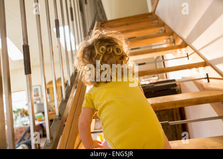 Caucasian baby boy crawling up stairs Stock Photo