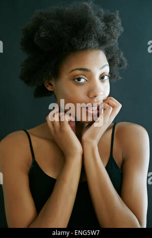 Close up of black woman biting fingernails Stock Photo