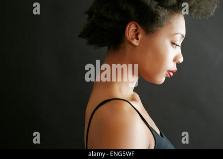 Close up profile of black woman looking down Stock Photo