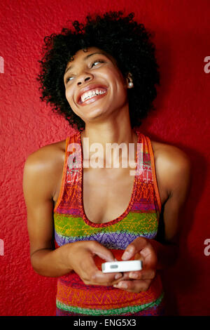 Smiling black woman using cell phone Stock Photo