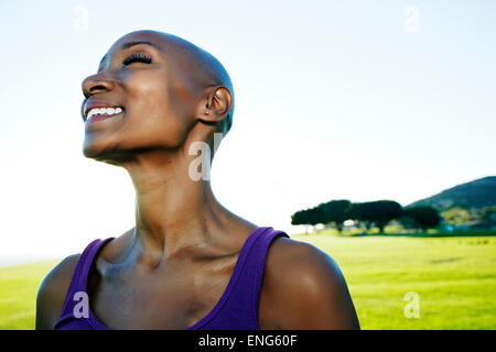 African American woman smiling in park Stock Photo
