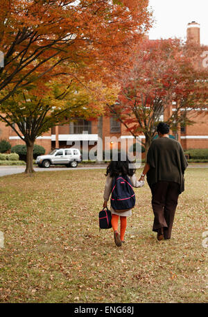 African American mother walking daughter to school Stock Photo