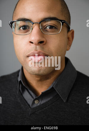 Close up of mixed race man wearing eyeglasses Stock Photo