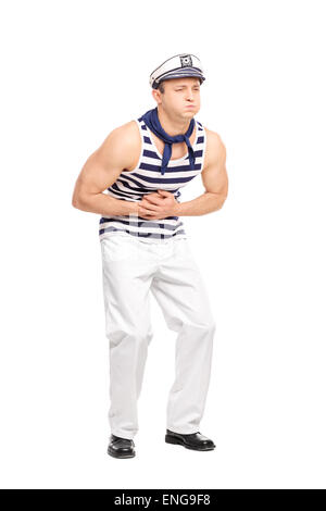Full length portrait of a young male sailor feeling stomach ache isolated on white background Stock Photo