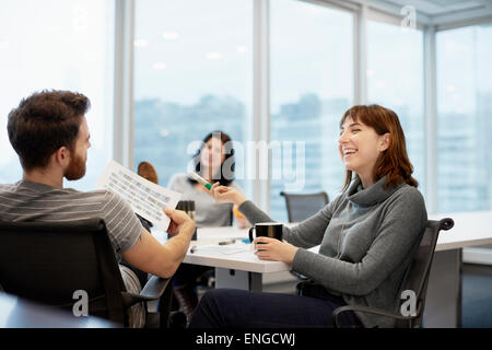 Three business people, two women and a man Stock Photo