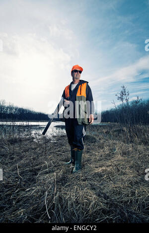 A man holdng a rifle under his arm, a hunter. Stock Photo