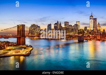 New York City, USA skyline over East River and Brooklyn Bridge.