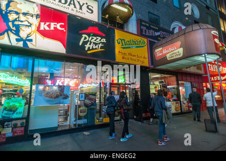 Signs for an assortment of fast food franchises located in one storefront in New York on Tuesday, April 28, 2015. (© Richard B. Levine) Stock Photo