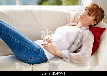 Girl holding her abdomen Stock Photo