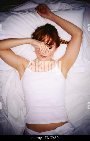 Girl laid in bed not able to sleep Stock Photo