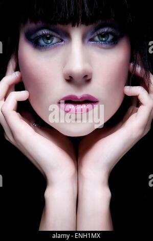 Symmetrical beauty headshot of young Caucasian woman with hands framing her face Stock Photo