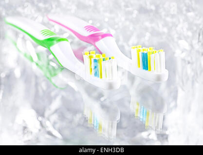 Two tooth brushes on bright background, high key effect. Stock Photo