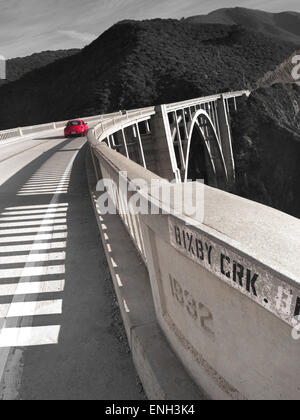 BIXBY BRIDGE Retro Americana B&W Tone treatment with red car crossing Bixby Bridge at Big Sur, Monterey, California USA Stock Photo