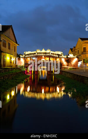 Japanese Covered Bridge reflected on canal, Hoi An, Vietnam Stock Photo