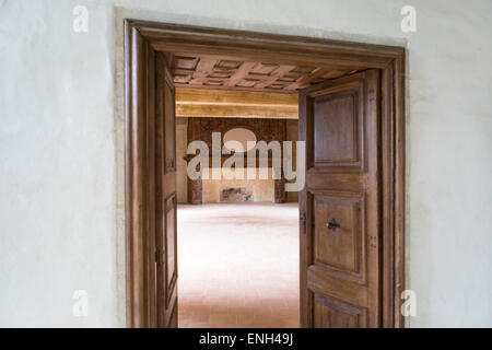 Room with doors and an enormous fireplace at castle Bruniquel, Tarn et Garonne, Midi-Pyrenees, France Stock Photo