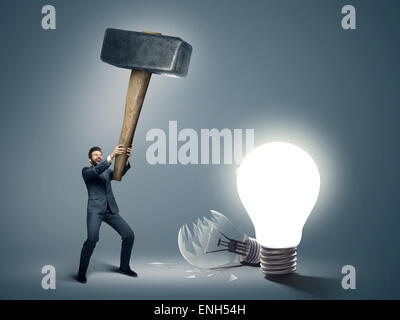 Conceptual image of a businessman holding huge hammer Stock Photo