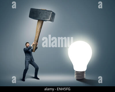 Conceptual image of a businessman holding big hammer Stock Photo