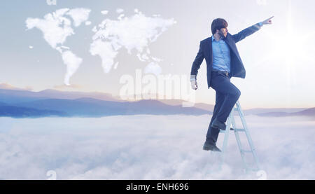 Conceptual picture of businessman over the cloud world map Stock Photo