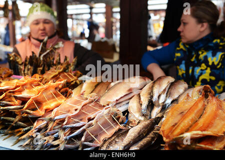 Russian vendors selling the famous smoked Omul fish in Listvyanka on the shore of lake Baikal. Stock Photo