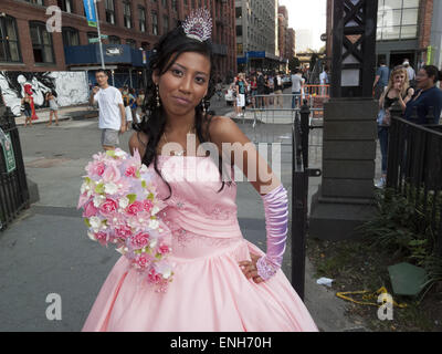 Mexican girl has photo taken for her fifteenth birthday or Quinceañera at Brooklyn Bridge Park in in DUMBO in Brooklyn, NY. Stock Photo